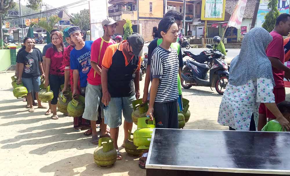 Warga antre untuk membeli gas 3 kg yang dijual dalam pasar murah Minggu (10/06/2018)