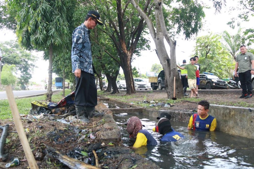 Walikota Palembang Harnojoyo saat meninjau petugas membersihkan saluran air. 