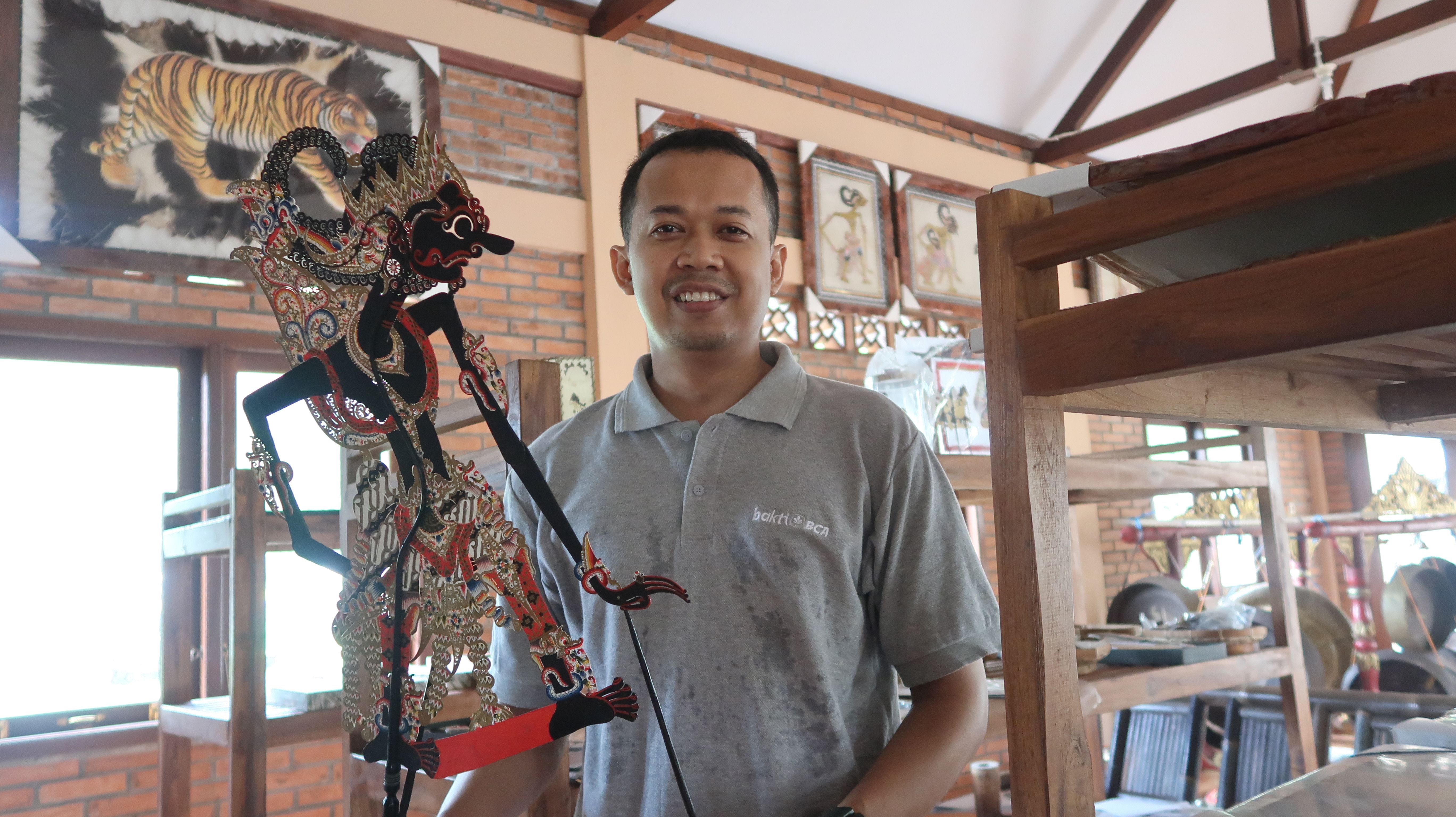 Demy Raharja, Ketua Pengelola Desa Wisata Wayang tengah menunjukkan wayang di workshop.