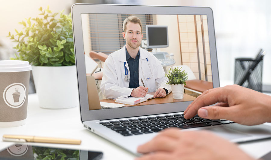 <p>Doctor with a stethoscope on the computer laptop screen. Telemedicine or telehealth concept.</p>
