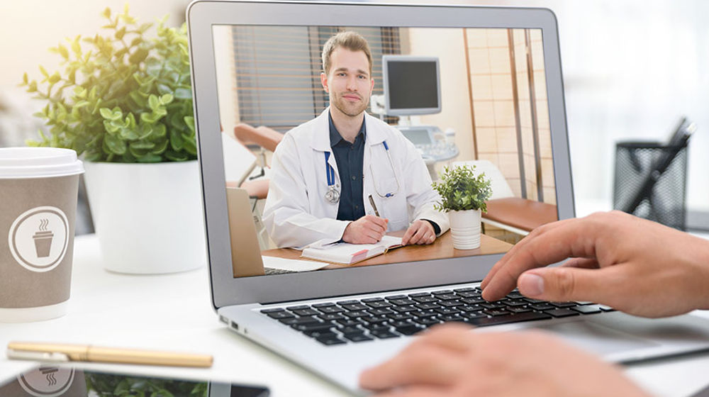 <p>Doctor with a stethoscope on the computer laptop screen. Telemedicine or telehealth concept.</p>
