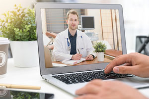<p>Doctor with a stethoscope on the computer laptop screen. Telemedicine or telehealth concept.</p>