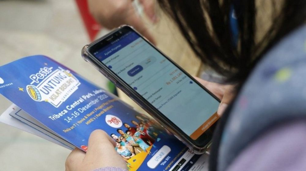Seorang peminjam tengah mengajukan pinjaman melalui aplikasi Fintech P2P Lending UangTeman