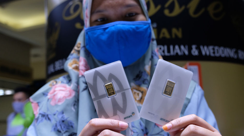 <p>Pramuniaga menunjukkan emas batangan di Cikini Gold Center, Jakarta, Rabu (8/4/2020). Harga emas 24 karat keluaran Logam Mulia PT Aneka Tambang Tbk (ANTM) turun Rp 17.000 per gram pada Rabu (8/4) berada di posisi Rp 946.000 per 1 Gram, setelah tembus rekor tertinggi sepanjang sejarah pada harga Rp 963.000 per 1 Gram pada Selasa (7/4). Foto: Ismail Pohan/TrenAsia</p>
