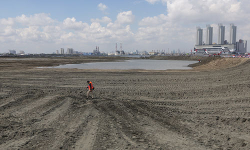 <p>Pekerja melintas di salah satu lokasi reklamasi Teluk Jakarta di Pulau G, Jakarta.  Foto: Ismail Pohan/TrenAsia</p>
