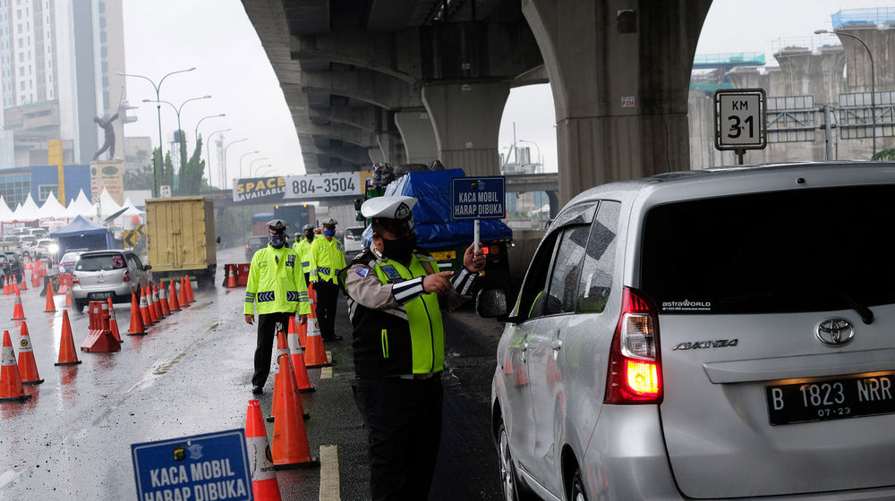 <p>Petuga kepolisian berjaga di pos penyekatan kendaraan melalui Tol Jakarta-Cikampek Km 31 di Cikarang Barat, Kabupaten Bekasi, Jawa Barat, Senin 18 Mei 2020. Memasuki H-6 Lebaran puluhan kendaraan masih terjaring razia penyekatan larangan mudik dan dipaksa putar balik keluar pintu tol kembali ke Jakarta. Walaupun larangan mudik diberlakukan sejak beberapa waktu lalu, sejumlah pemudik tetap nekat, mencoba mengelabui petugas, dan berharap lolos, dari pemeriksaan. Foto: Ismail Pohan/TrenAsia</p>
