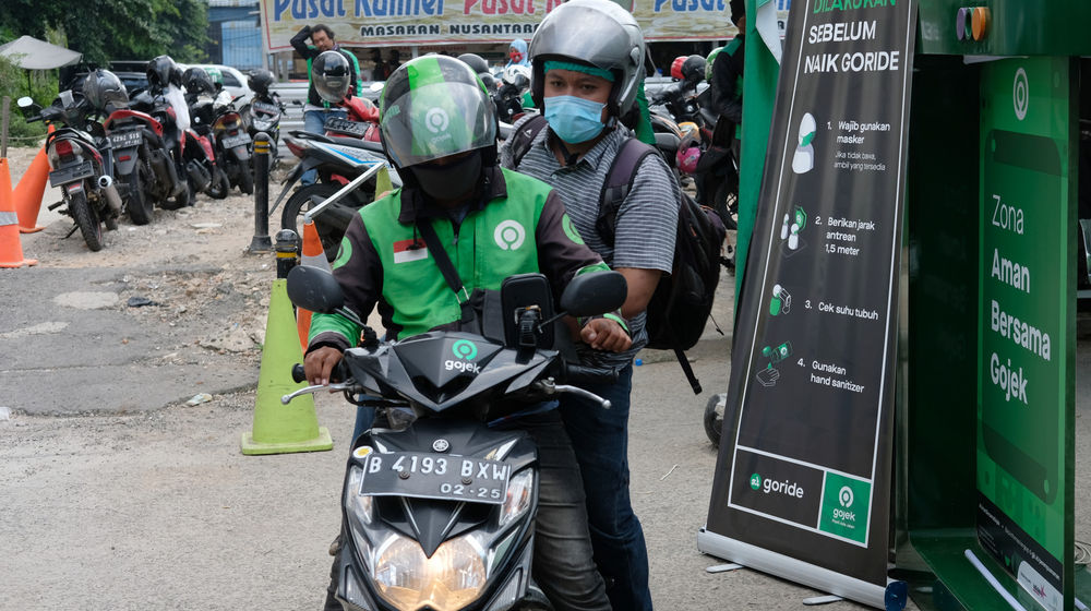 <p>Ojek online mangambil penumpang di kawasan stasiun Sudirman, Jakarta, Senin 8 Juni 2020. Setelah Pemerintah Provinsi DKI Jakarta melonggarkan pembatasan sosial berskala besar (PSBB) dan memasuki fase transisi, mulai Senin 8 Juni 2020, layanan ojek online GoRide dan Grab Bike sudah bisa digunakan kembali oleh masyarakat. Foto: Ismail Pohan/TrenAsia</p>