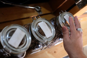 <p>Ahmad Hilmy Almusawa (22) penyandang tuna netra membaca huruf braille saat memilih biji kopi untuk pesanan pelanggan di gerainya “Mata Hati Koffie”, kawasan Pondok Cabe, Tangerang Selatan, Kamis, 23 Juli 2020. Meski dalam situasi pandemi, Hilmy yang sudah mengalami kebutaan sejak umur 12 tahun ini tetap semangat meracik kopi dengan hati di gerai miliknya sendiri tersebut. Omset yang menurun tidak serta merta menurunkan semangatnya untuk tetap menjalankan bisnisnya dengan sepenuh hati melayani setiap penikmat kopi yang datang tak terkecuali pelanggan setianya. Foto: Ismail Pohan/TrenAsia</p>
