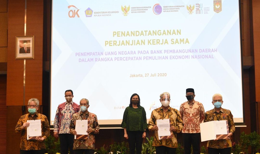 <p>Penandatanganan perjanjian kerja sama dilakukan oleh Direktur Utama Bank DKI Zainuddin Mappa dengan Direktur Jenderal Perbendaharaan Kementerian Keuangan Andin Hadyanto, serta disaksikan oleh Menteri Keuangan Sri Mulyani dan Gubernur DKI Jakarta Anies Baswedan di Jakarta, Senin, 27 Juli 2020. / Bank DKI</p>
