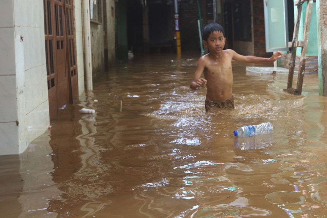 <p>Warga beraktivitas saat banjir merendam pemukiman padat di dekat bantaran kali Ciliwung kawasan Kebun Pala, Jakarta Timur, Selasa 22 September 2020. Curah hujan tinggi dan tingginya debit air di bendung katulampa Bogor, membuat sejumlah pemukiman warga yang berada di bantaran Ciliwung wilayah Jakarta terendam banjir. Foto: Ismail Pohan/TrenAsia</p>
