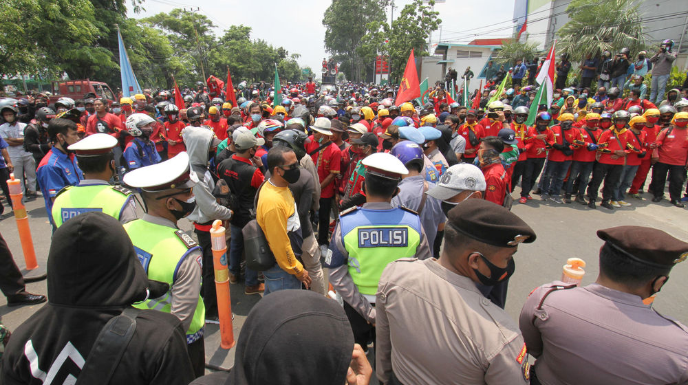 <p>Aparat kepolisian tampak mengawal buruh yang mengikuti aksi unjuk rasa di Jalan Daan Mogot, Kota Tangerang, Banten, Rabu, 7 Oktober 2020. Aksi tersebut sebagai bentuk kekecewaan buruh atas pengesahan Undang-Undang Cipta Kerja oleh DPR yang dianggap merugikan kaum buruh. Foto: Panji Asmoro/TrenAsia</p>
