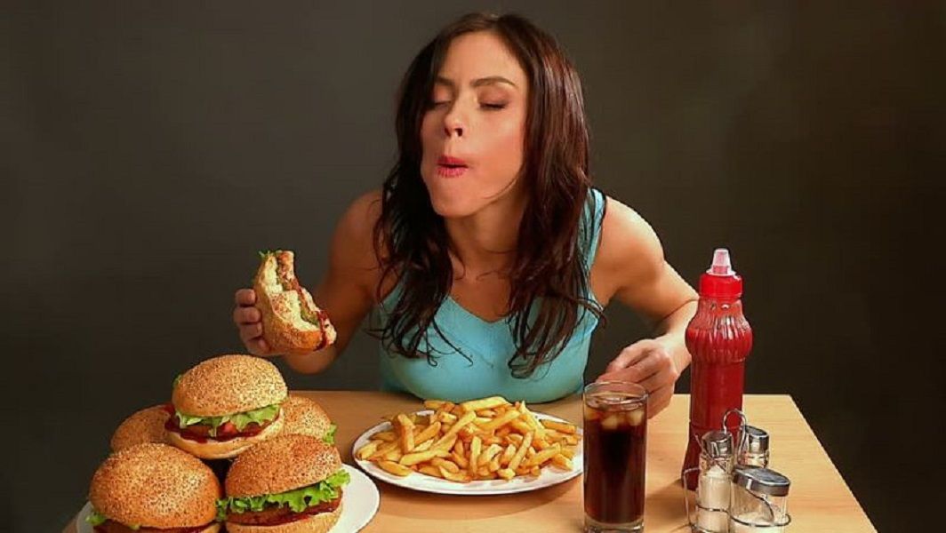 <p>Ilustrasi memakan makanan cepat saji / Shutterstock</p>
