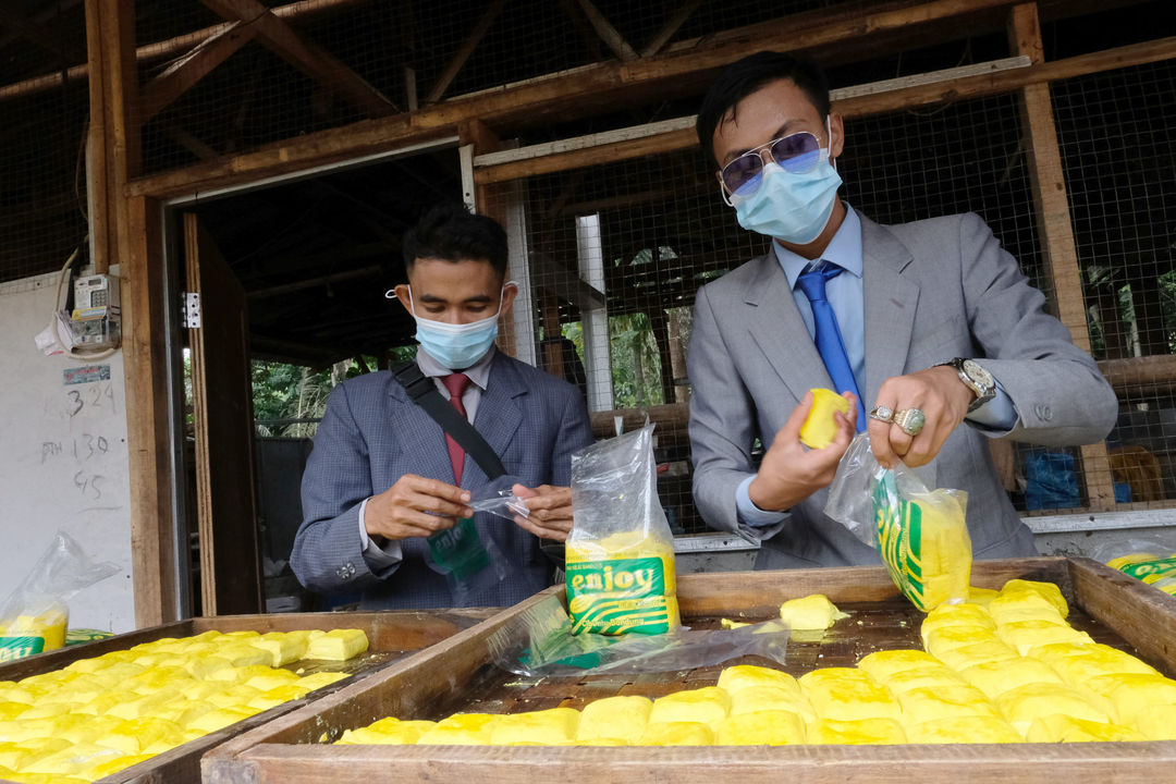 <p>Pekerja mengenakan busana formil jas, kemeja, dan berdasi layaknya pekerja kantoran melakukan pengepakan tahu di industri rumahan Usaha Mikro Kecil Menengah (UMKM) kawasan Sukaraja, Kabupaten Bogor, Jawa Barat, Senin, 14 Desember 2020. Foto : Ismail Pohan/TrenAsia</p>
