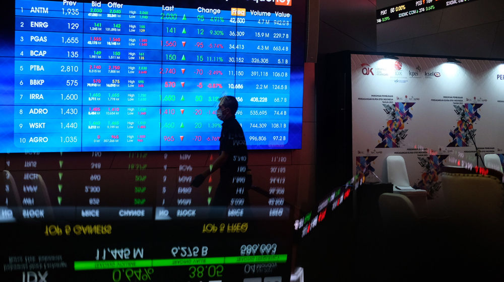 <p>Karyawan melintas dengan latar belakang layar pergerakan Indeks Harga Saham Gabungan (IHSG) di gedung Bursa Efek Indonesia (BEI), Jakarta, Senin, 4 Januari 2021. Foto: Ismail Pohan/TrenAsia</p>
