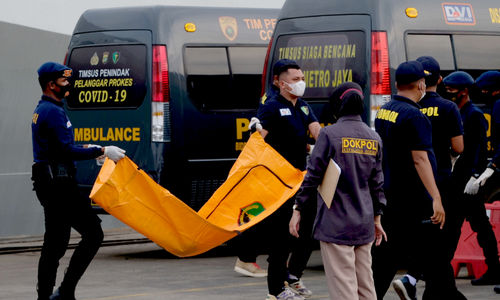 <p>Tim DVI Polri membawa kantong yang berisi potongan jenazah korban jatuhnya pesawat Sriwijaya Air SJ 182 untuk diserahkan ke RS Polri dari posko evakuasi Dermaga JICT 2, Tanjung Priok, Jakarta Utara, Senin, 11 Januari 2021. Foto: Ismail Pohan/TrenAsia</p>