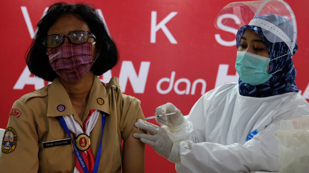 <p>Petugas menyuntikkan vaksin kepada tenaga pendidikan saat vaksinasi tahap II untuk tenaga pendidik, guru, dan dosen di SMA Negeri 70 Jakarta, Rabu, 24 Februari 2021. Foto: Ismail Pohan/TrenAsia</p>
