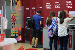 <p>Nasabah melakukan transaksi melalui mesin ATM di gerai CIMB Niaga Ditigal Lounge, Mal Gandaria City, Jakarta, Kamis, 4 Maret 2021. Foto: Ismail Pohan/TrenAsia</p>
