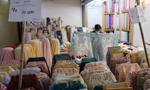 <p>Pedagang menunjukkan bahan kain di kios blok tekstil Pasar Tanah Abang, Jakarta, Rabu, 31 Maret 2021. Foto: Ismail Pohan/TrenAsia</p>
