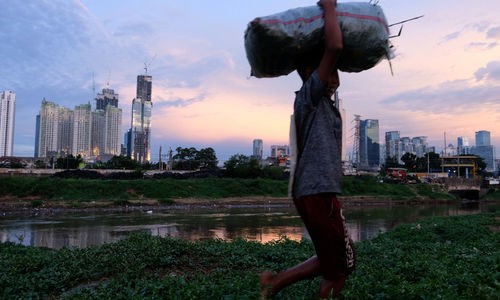 <p>Warga beraktivitas dengan latar belakang gedung bertingkat di kawasan Kebon Melati, Tanah Abang, Jakarta, Rabu, 24 Maret 2021. Foto: Ismail Pohan/TrenAsia</p>