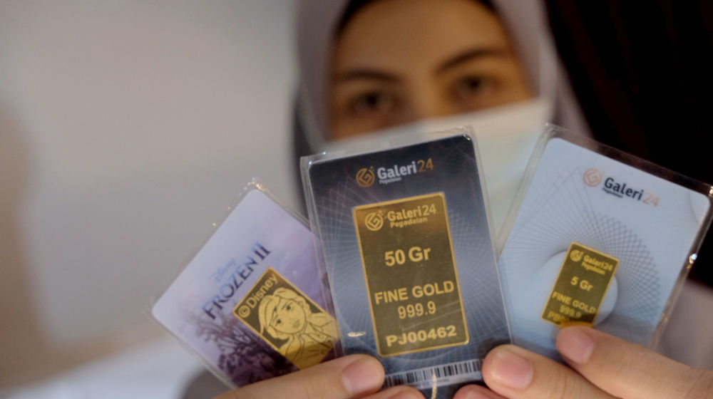 <p>Karyawati menunjukkan emas di gerai Galeri 24 Pegadaian, Jakarta, Senin, 1 Maret 2021. Foto: Ismail Pohan/TrenAsia</p>
