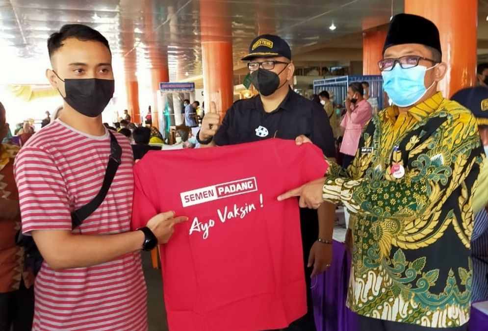 Plt Wali Kota Padang Hendri Septa memperlihatkan baju koas dari Semen Padang sebagai bentuk dukungan dalam kegiatan vaksinasi Covid-19. Foto: IST