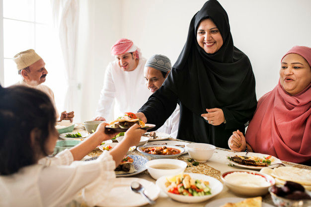 <p>Muslim woman sharing food at Ramadan feast</p>
