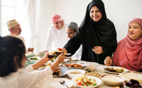 <p>Muslim woman sharing food at Ramadan feast</p>
