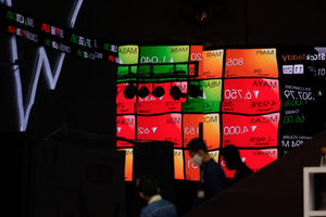 Karyawan melintas dengan latar layar pergerakan indeks harga saham gabungan (IHSG) di Gedung Bursa Efek 
