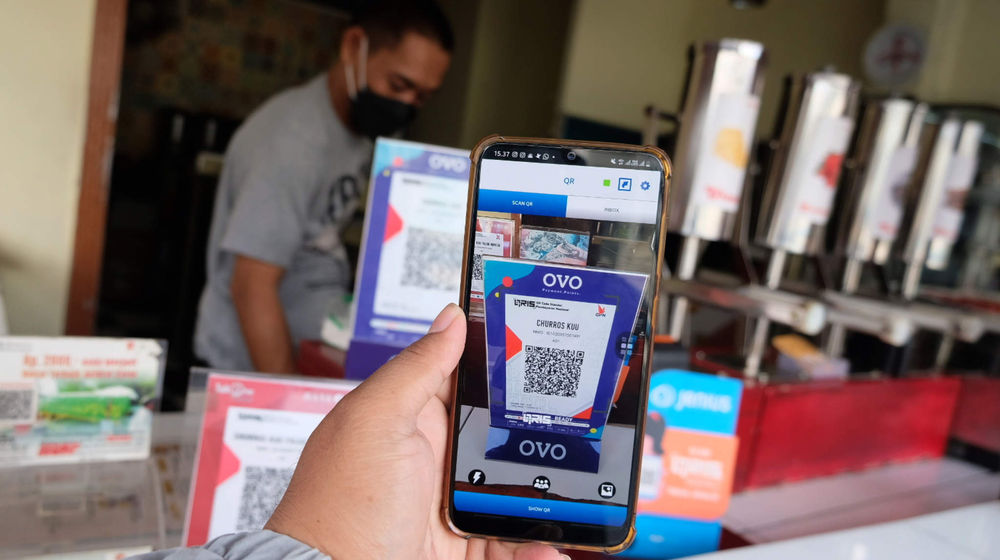 <p>Warga memindai kode batang atau QR Code saat bertransaksi digital di gerai makanan dan minuman ringan siap saji di kawasan Pasar Minggu, Jakarta, Selasa, 18 Mei 2021. Foto: Ismail Pohan/TrenAsia</p>
