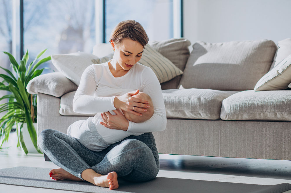 young-woman-breast-feeding-toddler-son-sitting-mat.jpg
