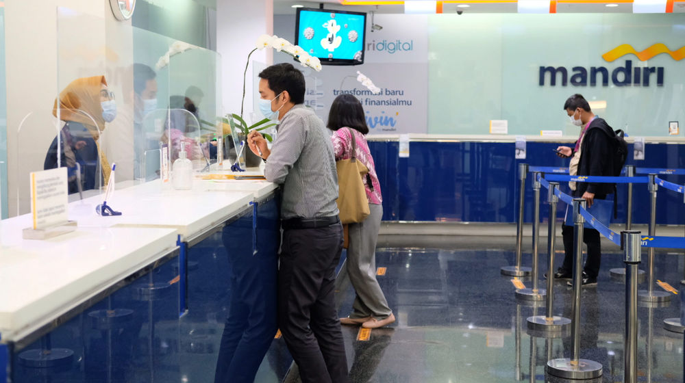 <p>Karyawan melayani nasabah di kantor cabang Bank Mandiri, Plaza Mandiri, Gatot Subroto, Jakarta, Selasa, 8 Juni 2021. Foto: Ismail Pohan/TrenAsia</p>
