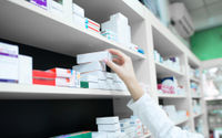 closeup-view-pharmacist-hand-taking-medicine-box-from-shelf-drug-store.jpg