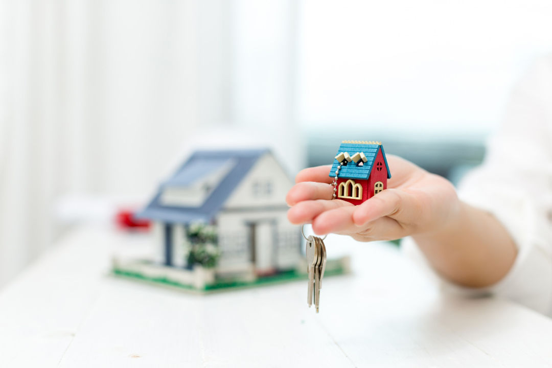 real-estate-agent-with-house-model-keys.jpg