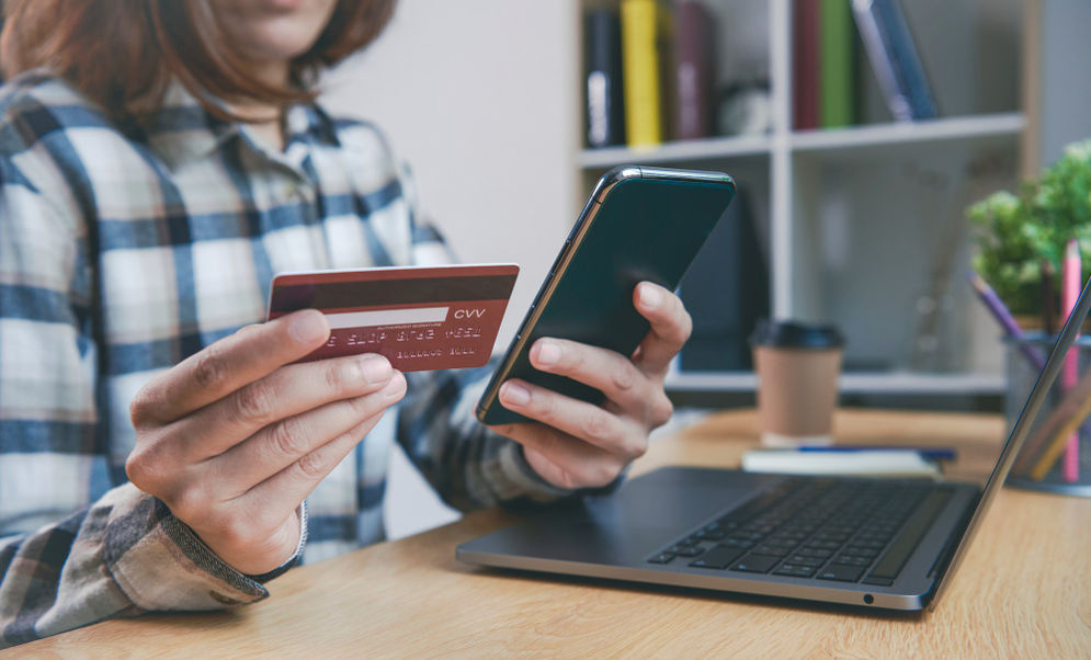 young-woman-holding-credit-card-using-smart-phone-buying-onl.jpg