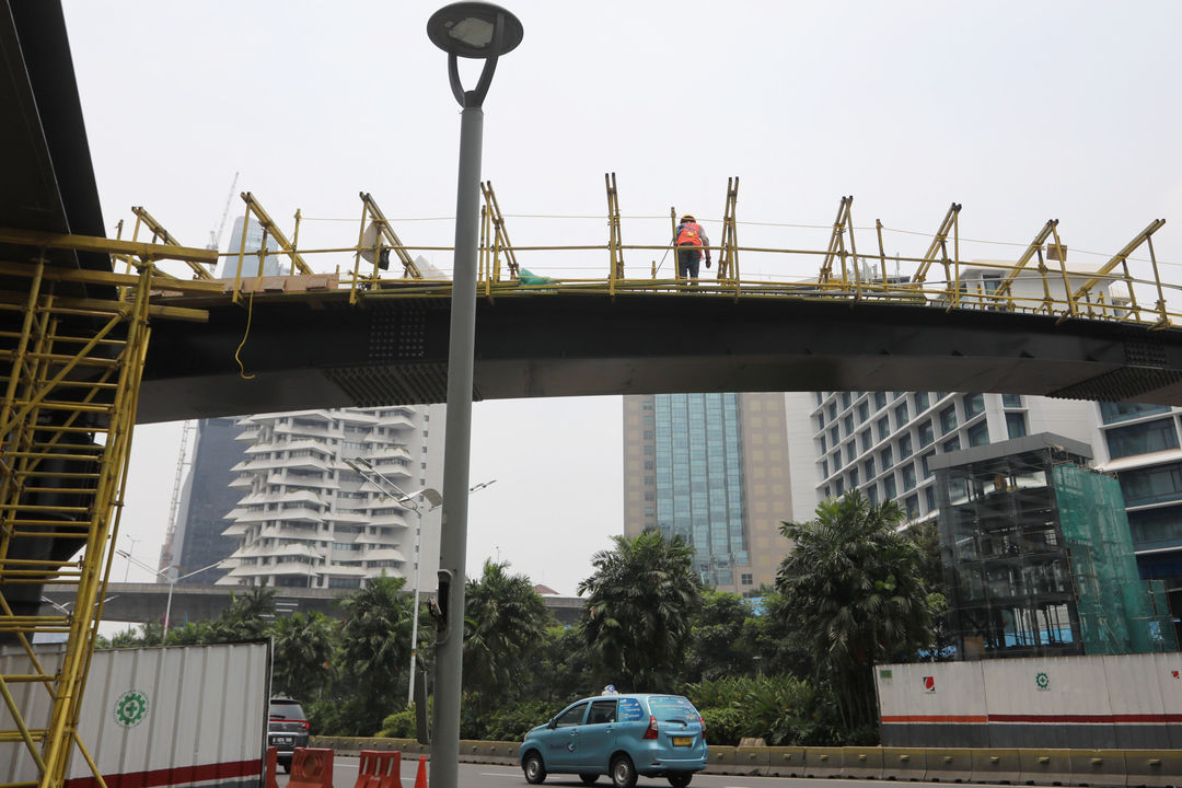 Suasana pengerjaan pembangunan jembatan penyeberangan multiguna (JPM) Dukuh Atas, di kawasan Sudirman, Jakarta, Kamis, 14 Oktober 2021. Foto: Ismail Pohan/TrenAsia