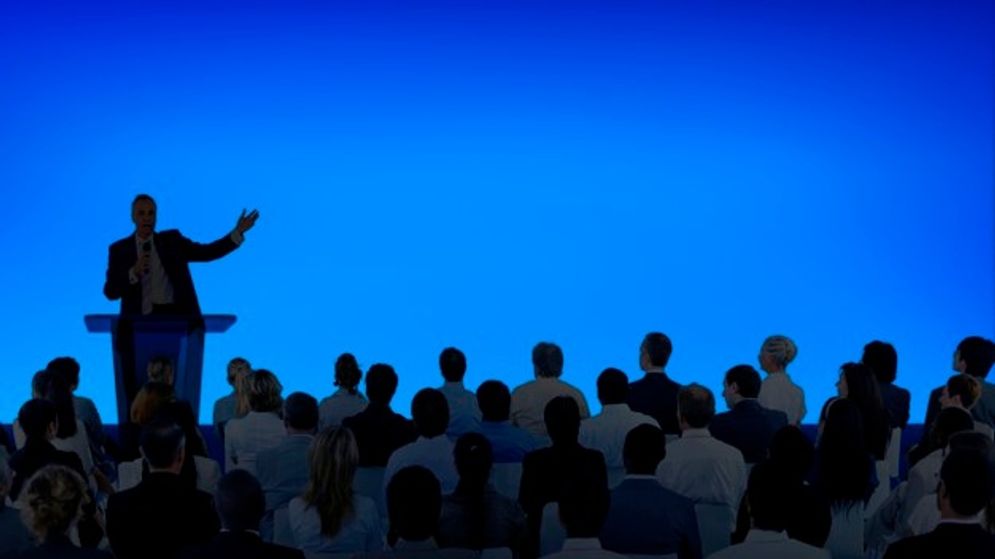 corporate-businessman-giving-presentation-large-audience_53876-101865.jpg