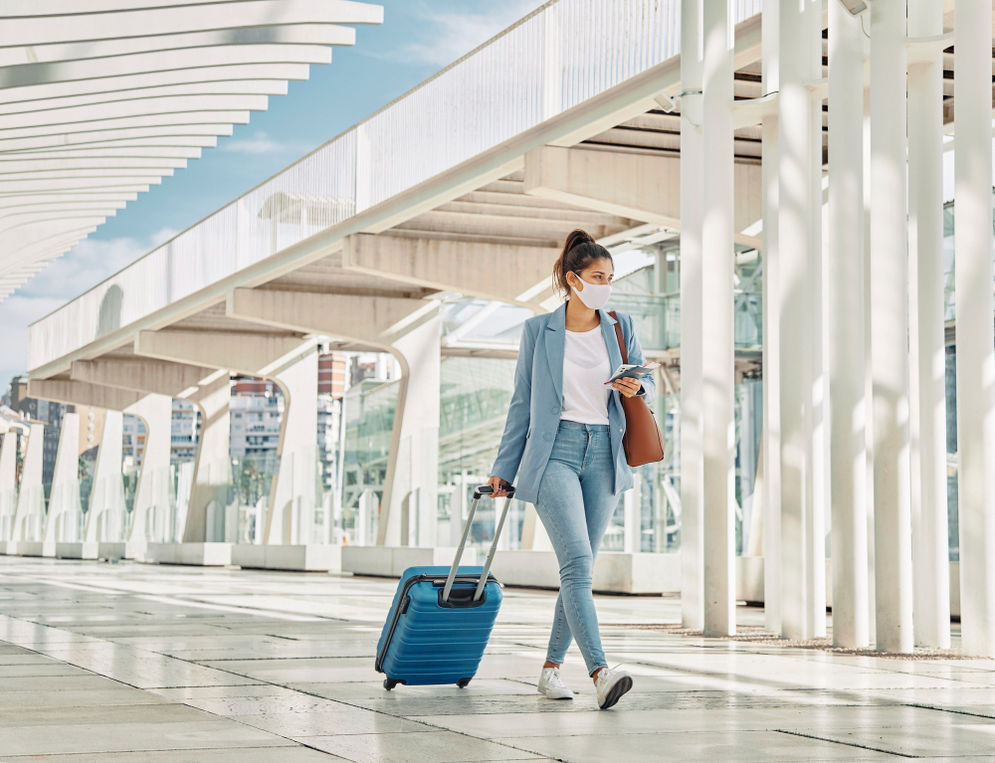 woman-with-luggage-during-pandemic-airport.jpg