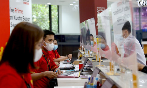 Karyawan melayani pelanggan di gerai Indosat Ooredoo, Jakarta, Rabu, 29 Desember 2021. Foto: Ismail Pohan/TrenAsia