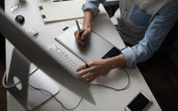 young-male-designer-using-graphics-tablet-while-working-with-com (1).jpg