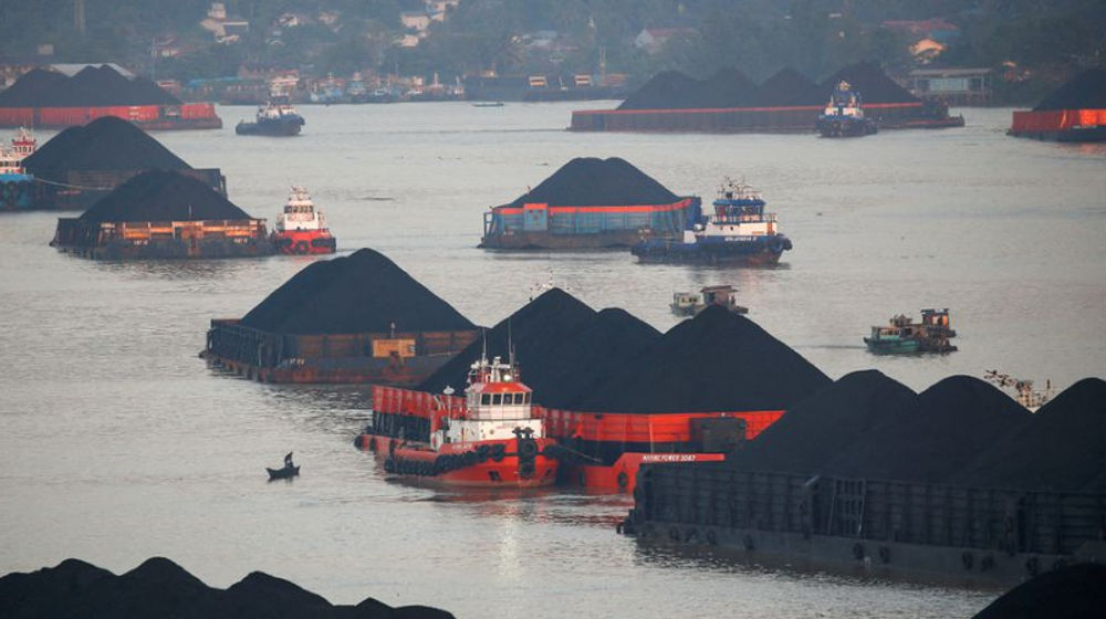 Coal barges are pictured as they queue to be pulled along Mahakam river in Samarinda, East Kalimantan province, Indonesia, August 31, 2019.jpg