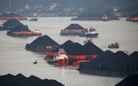 Coal barges are pictured as they queue to be pulled along Mahakam river in Samarinda, East Kalimantan province, Indonesia, August 31, 2019.jpg