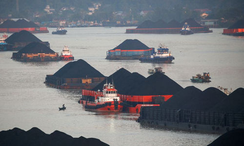 Coal barges are pictured as they queue to be pulled along Mahakam river in Samarinda, East Kalimantan province, Indonesia, August 31, 2019.jpg