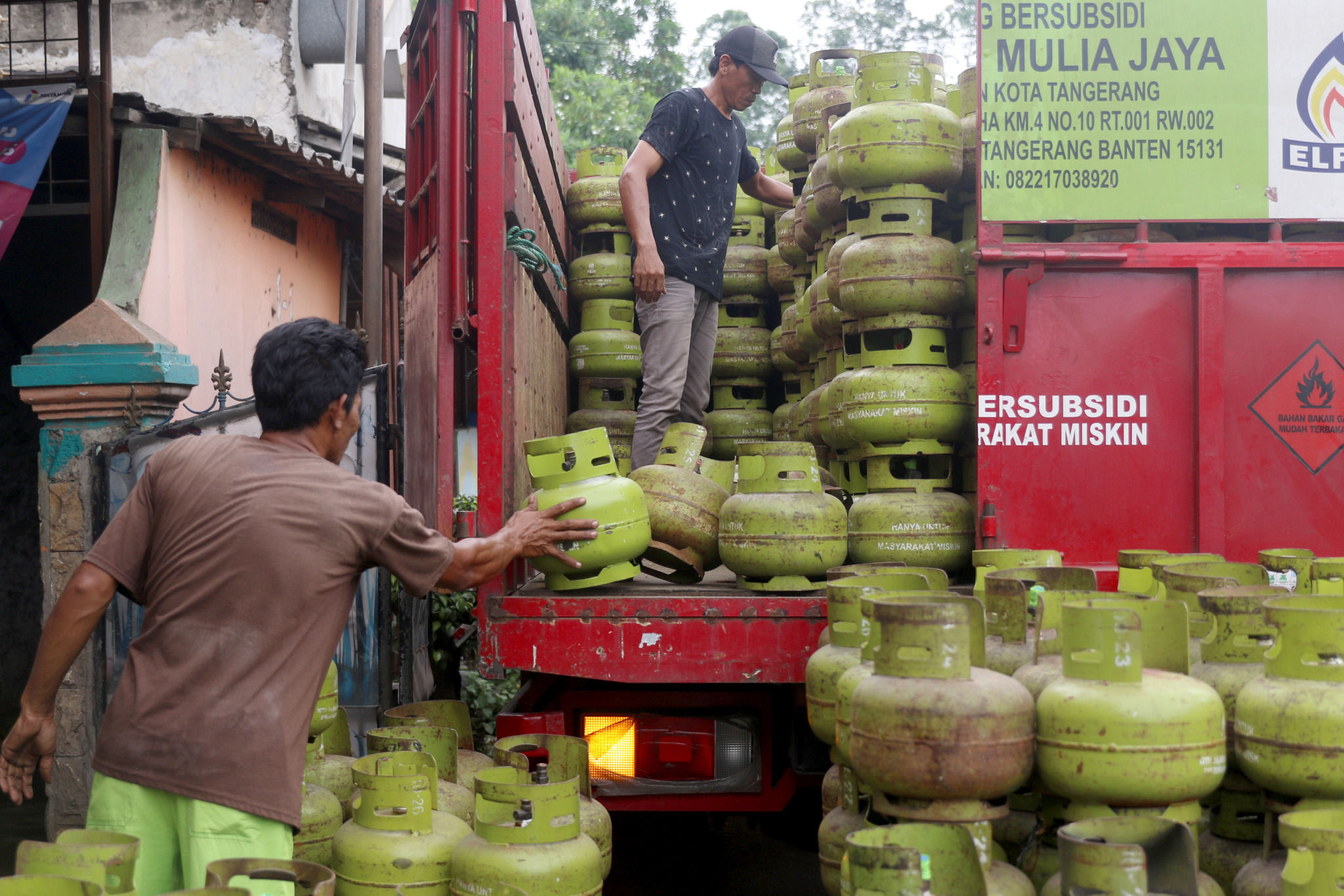 Pekerja melakukan bongkar muat tabung gas elpiji 3kg di salah satu agen kawasan Tangerang, Banten, Kamis, 24 Februari 2022. Foto: Ismail Pohan/TrenAsia