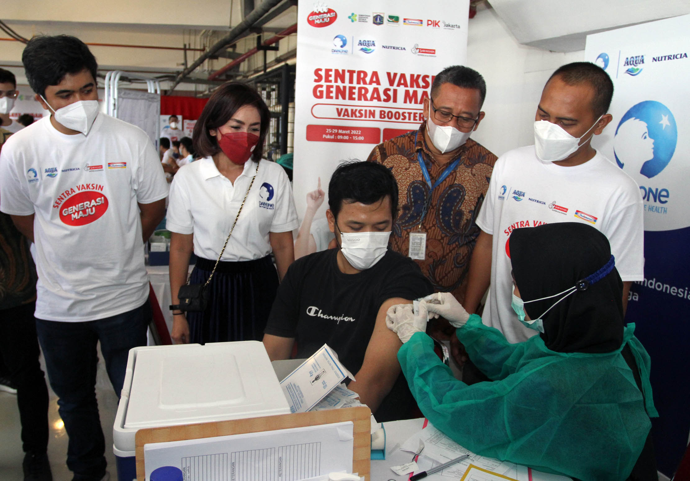 Government & External Scientific Affairs Lead Danone Indonesia dr. Sarah Angelique MS - CSR Manager Indomaret Untung Tri Haryono, dan perwakilan Walikota Dwi Panji Forkiantoro meninjau kegiatan Sentra Vaksinasi Generasi Maju Khusus Vaksin Booster yang diselenggarakan oleh Danone Indonesia bersama PT Indomarco Prismatama (Indomaret) di Jakarta Utara, Minggu 27 Maret 2022. Foto : Panji Asmoro/TrenAsia
