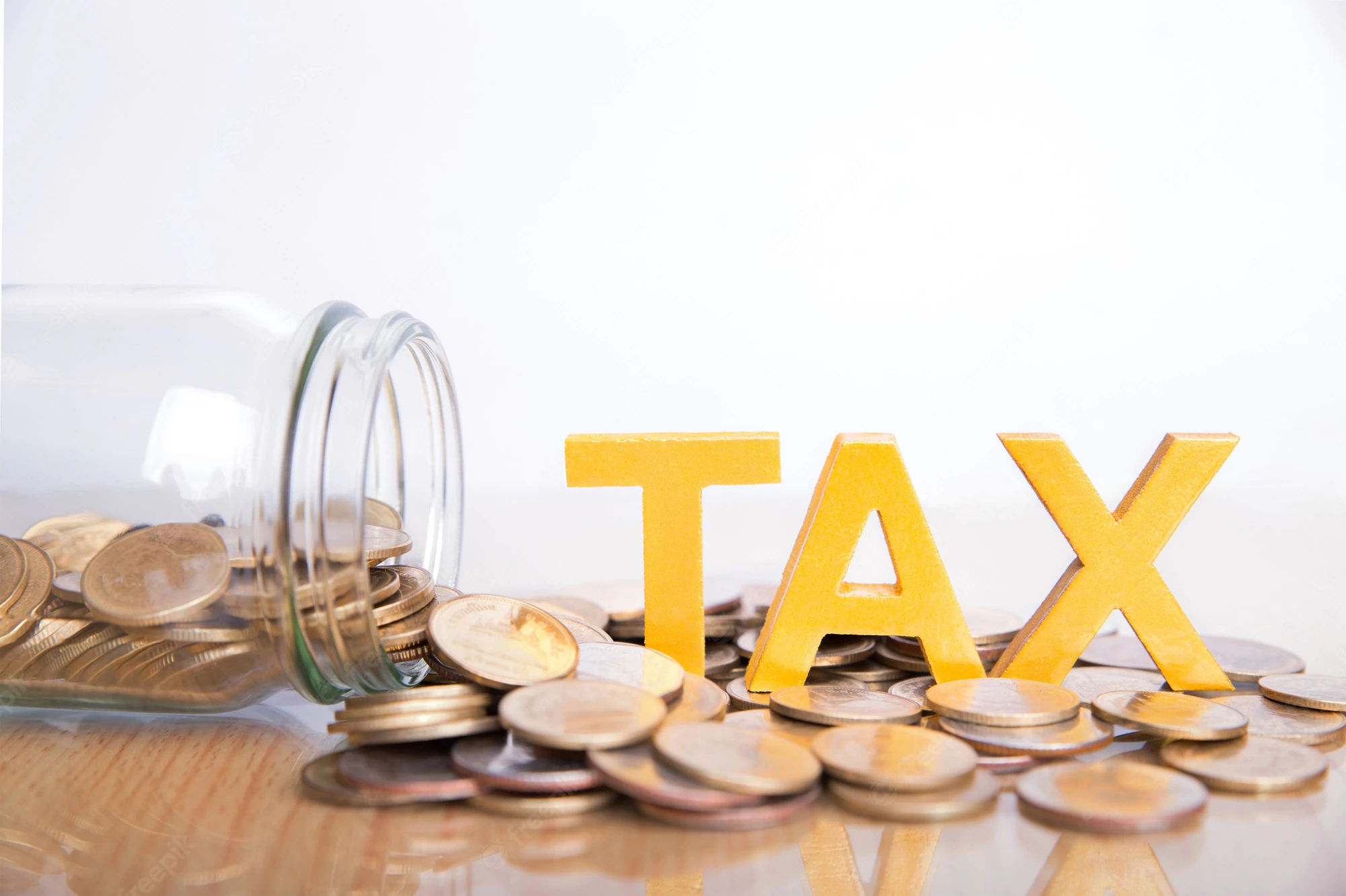 tax-concept-word-tax-put-coins-glass-bottles-with-coins-inside-white-background_38391-198.webp