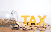 tax-concept-word-tax-put-coins-glass-bottles-with-coins-inside-white-background_38391-198.webp