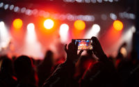 person-close-up-recording-video-with-smartphone-during-concert_1153-7416.webp