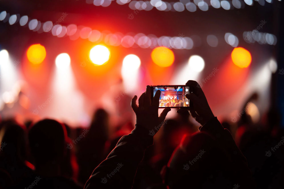 person-close-up-recording-video-with-smartphone-during-concert_1153-7416.webp