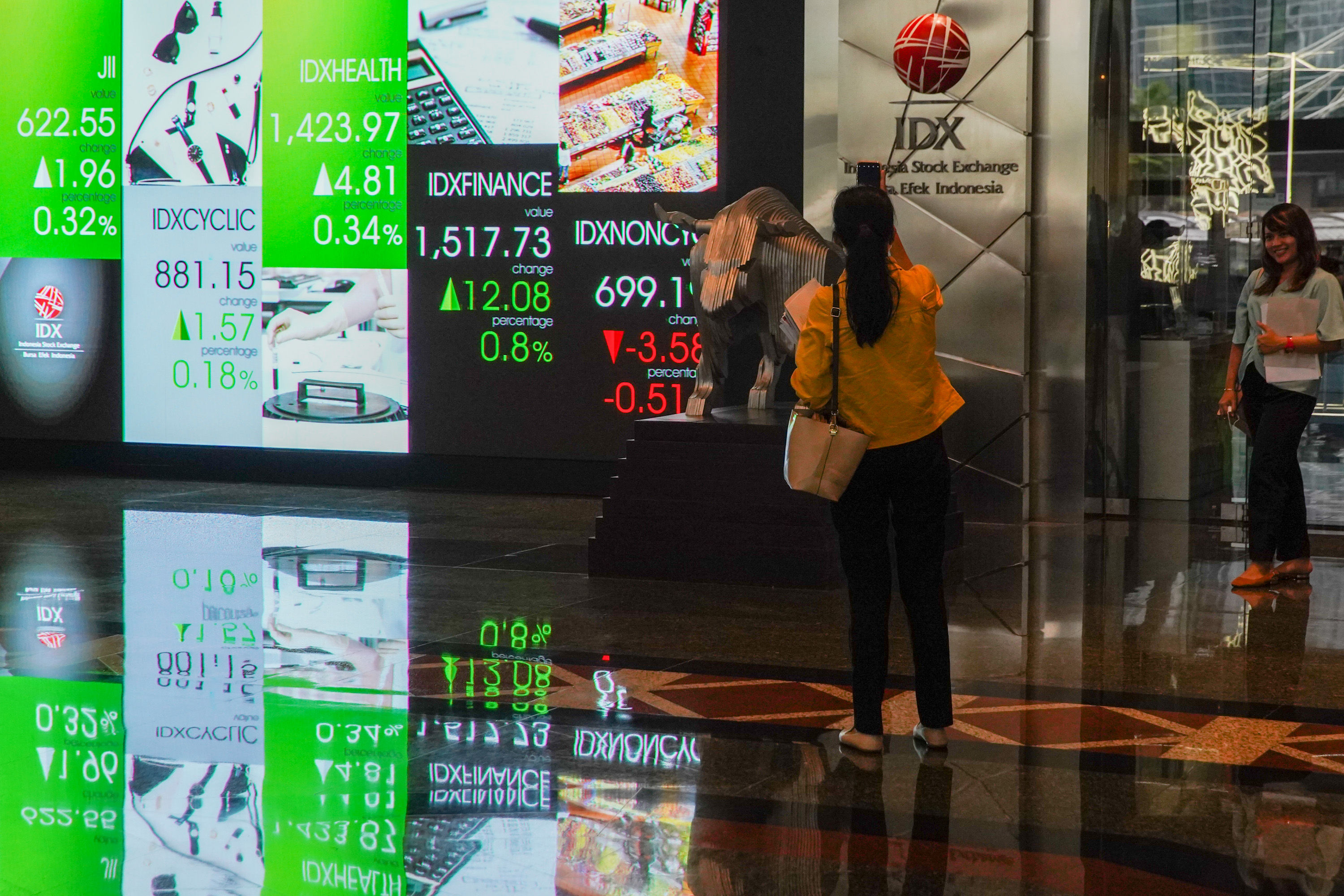 Karyawan berkatifitas dengan latar layar monitor pergerakan indeks harga saham gabungan (IHSG) di gedung Bursa Efek Indonesia (BEI), Jakarta, 8 September 2022. Foto: Ismail Pohan/TrenAsia