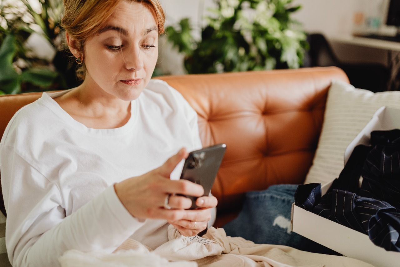 Photo by Karolina Grabowska: https://www.pexels.com/photo/woman-sitting-on-a-couch-using-her-phone-5902269/